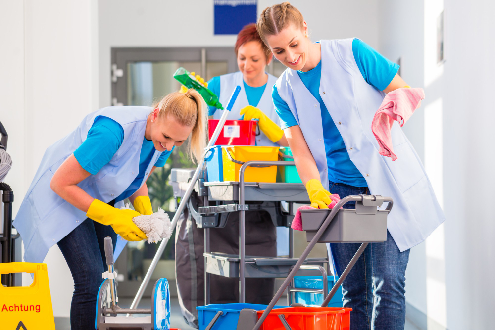 commercial-cleaners-doing-job-together-three-women-with-trolley-working