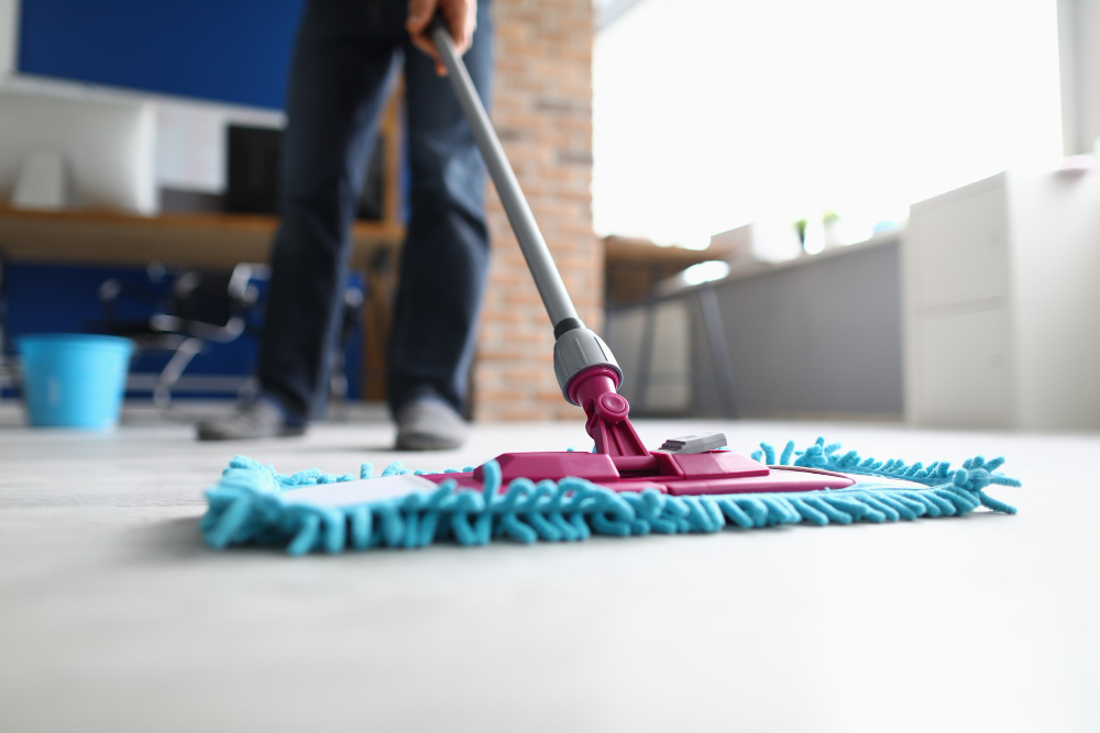 man-with-mop-washes-floor-office-cleaning-company-services-concept